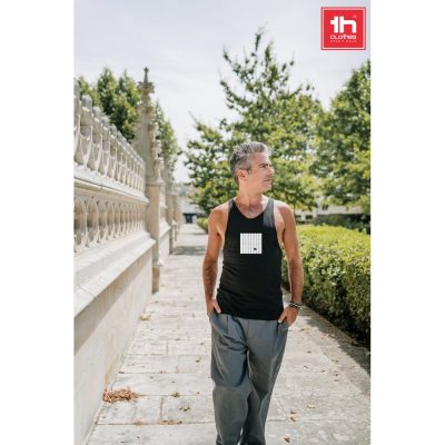 Man in black vest walking outdoors