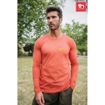 Man in orange long-sleeve shirt outdoors