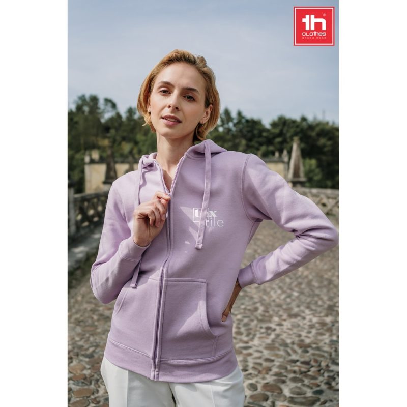 Person in lilac hoodie outdoors.