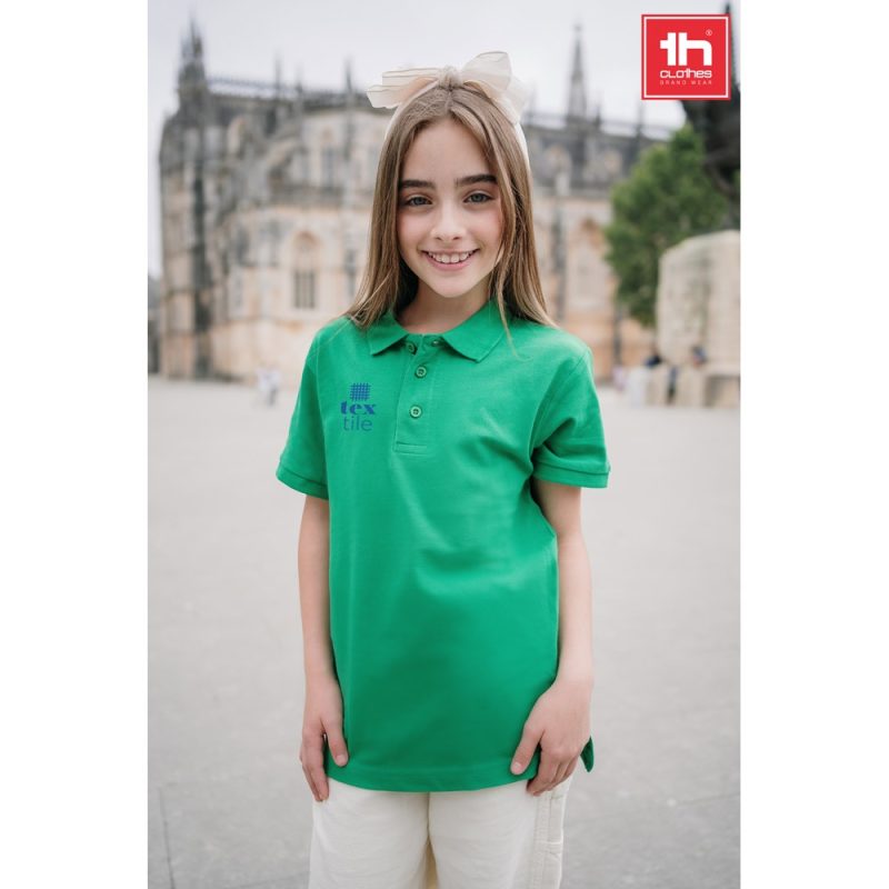 Girl wearing green polo shirt outdoors