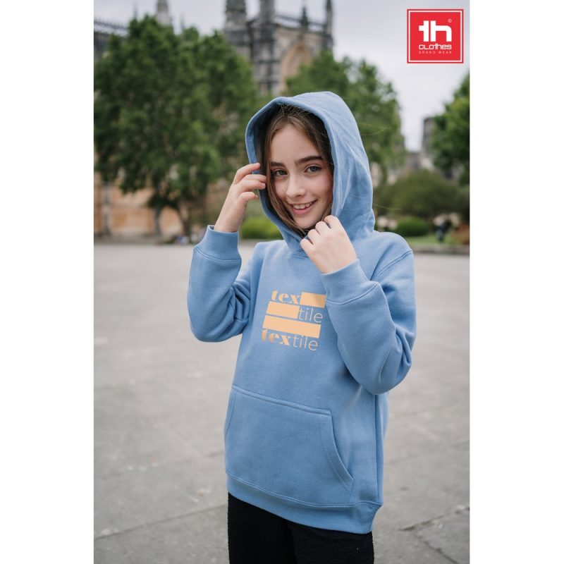 Smiling girl in blue hoodie outdoors