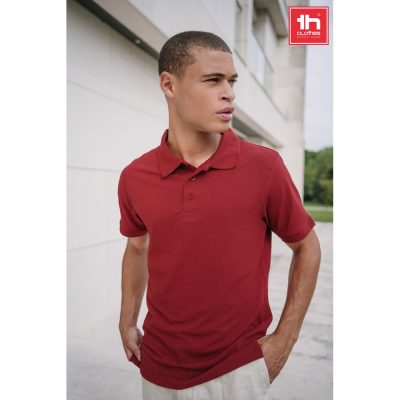 Man wearing red polo shirt outdoors.
