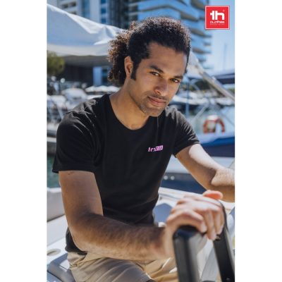 Man in black t-shirt on a boat.