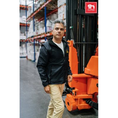 Man in warehouse with forklift.