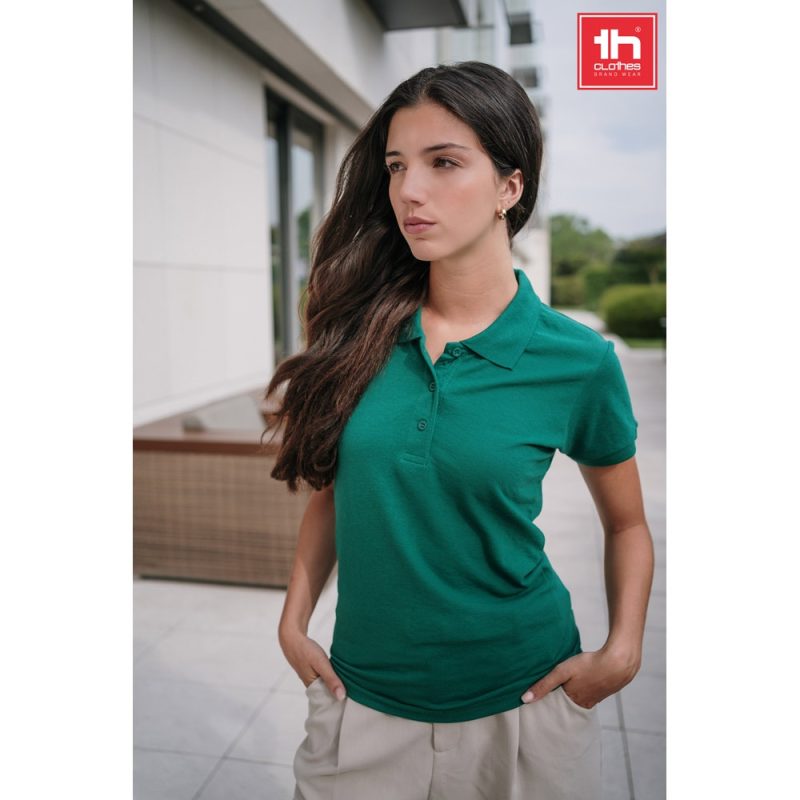 Woman in green polo shirt outdoors