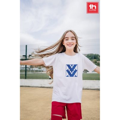 Smiling girl in sportswear on playground.