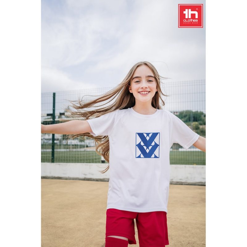 Smiling girl in sportswear on playground.
