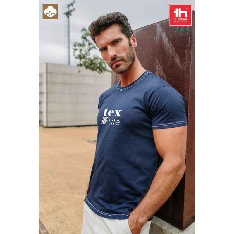 Man in navy t-shirt outdoors, branded Tex Tile.