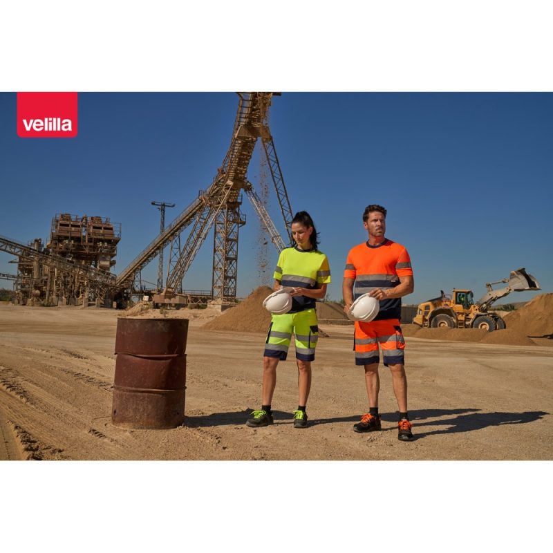 Workers in high-visibility gear at construction site.