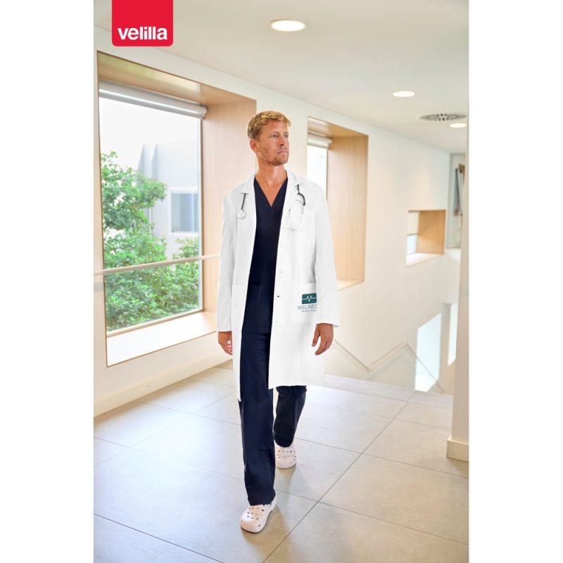 Doctor in hallway wearing white coat.