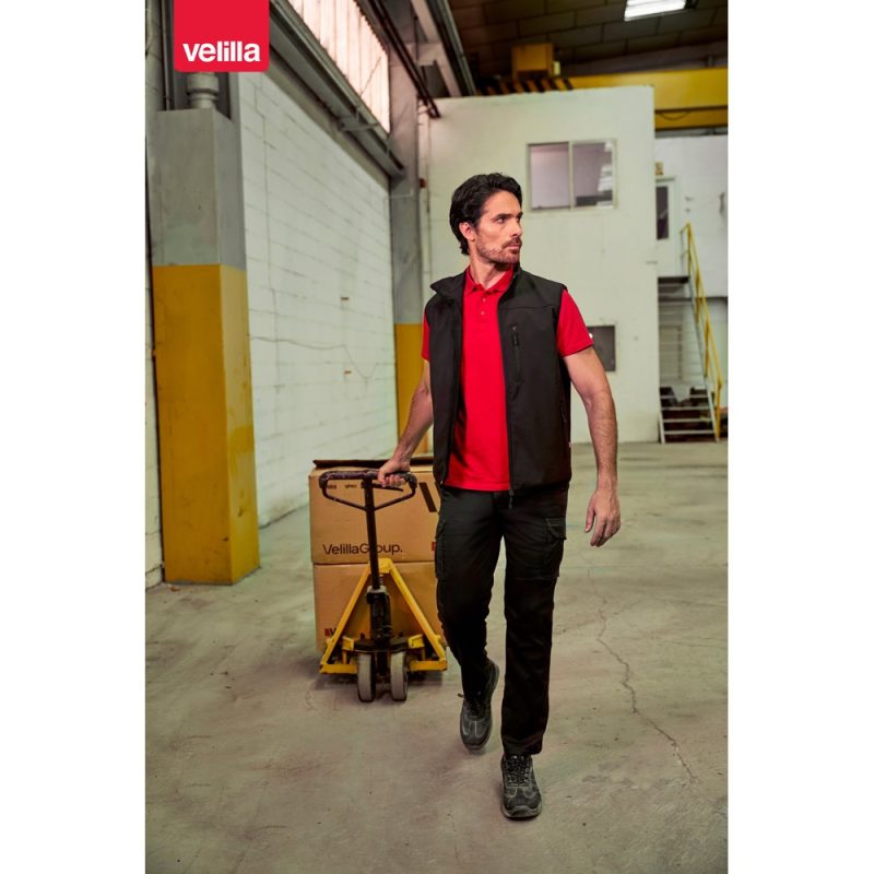 Warehouse worker pushing trolley with box