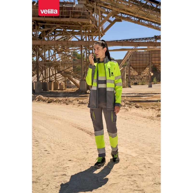 Person in high-visibility workwear at construction site.