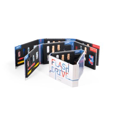 Collection of USB flash drives displayed in book.