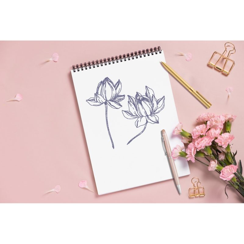 Sketchbook with flower drawings on pink background.