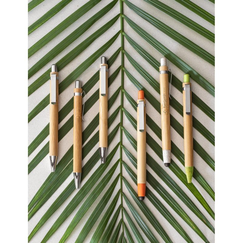 Eco-friendly bamboo pens on green leaves