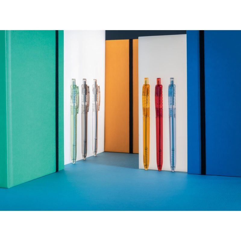 Colourful pens with matching notebooks background.