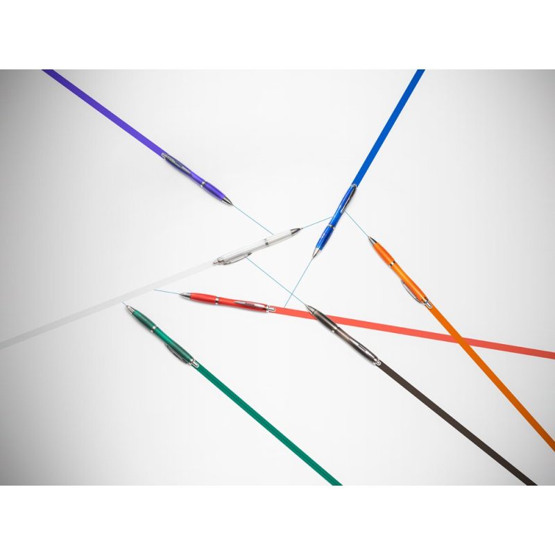 Colourful pens on white surface forming lines