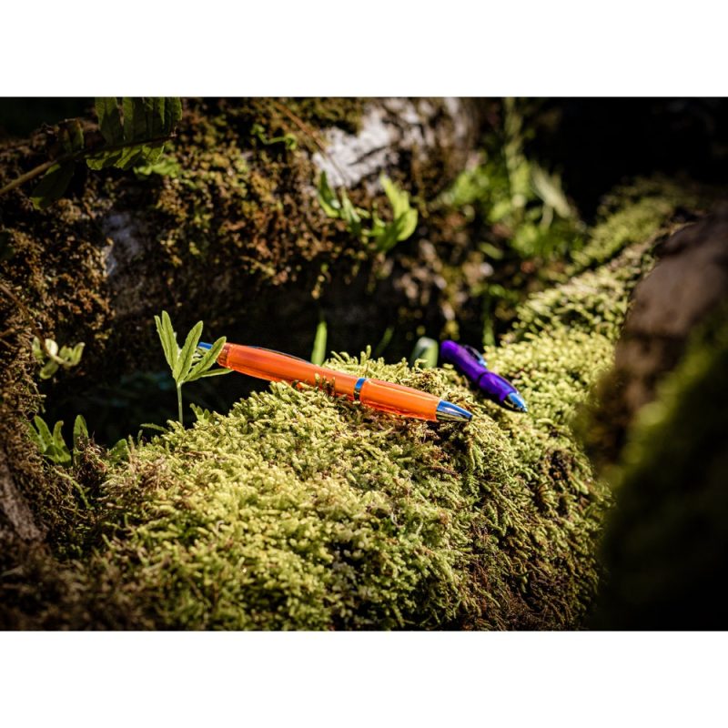 Two pens on moss-covered forest log