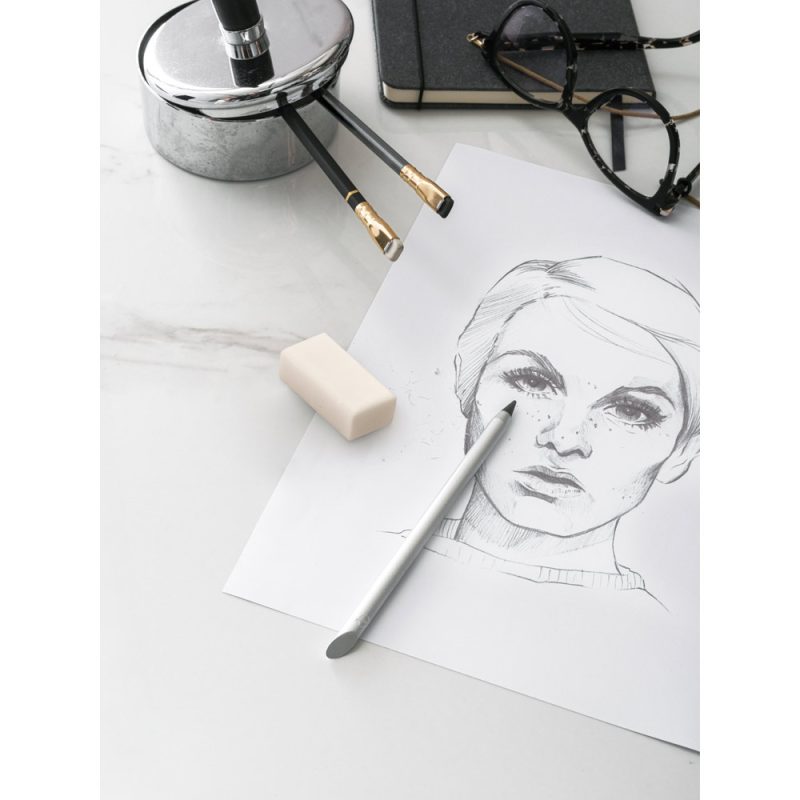 Pencil sketch of a woman's face on paper.