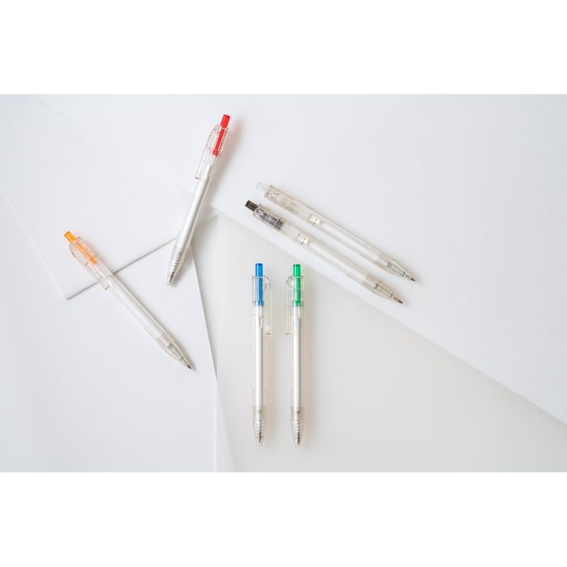 Assorted colourful pens on white paper background.