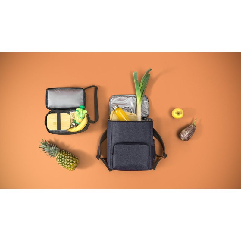 Lunch bags with fruits and vegetables on orange background.