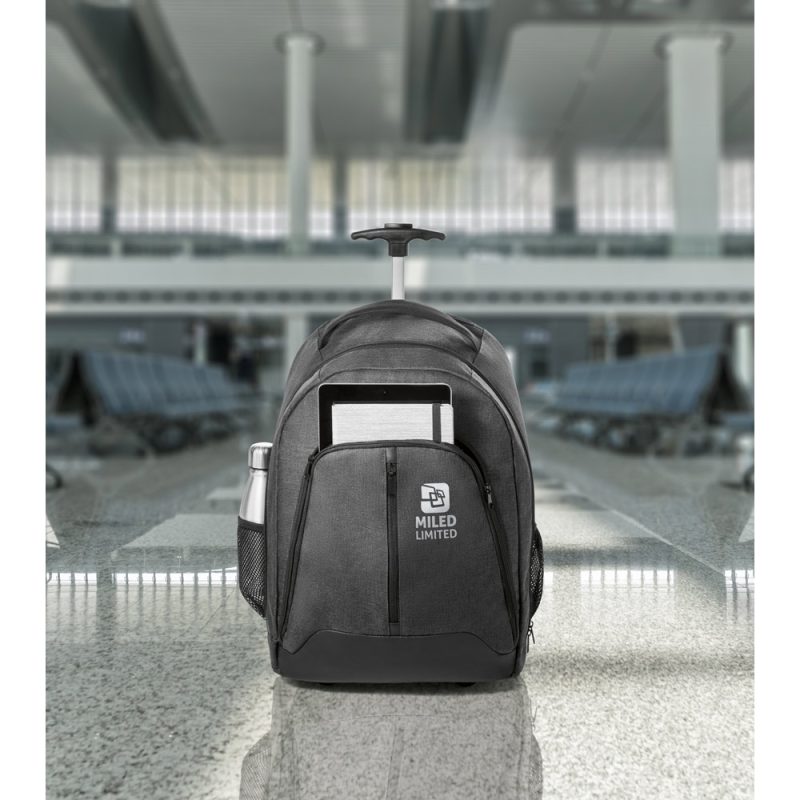Wheeled backpack with gadgets in modern airport.