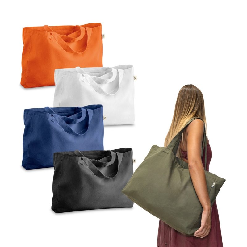 Colourful reusable tote bags and woman holding one.