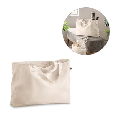 Beige cotton tote bag on table with items.