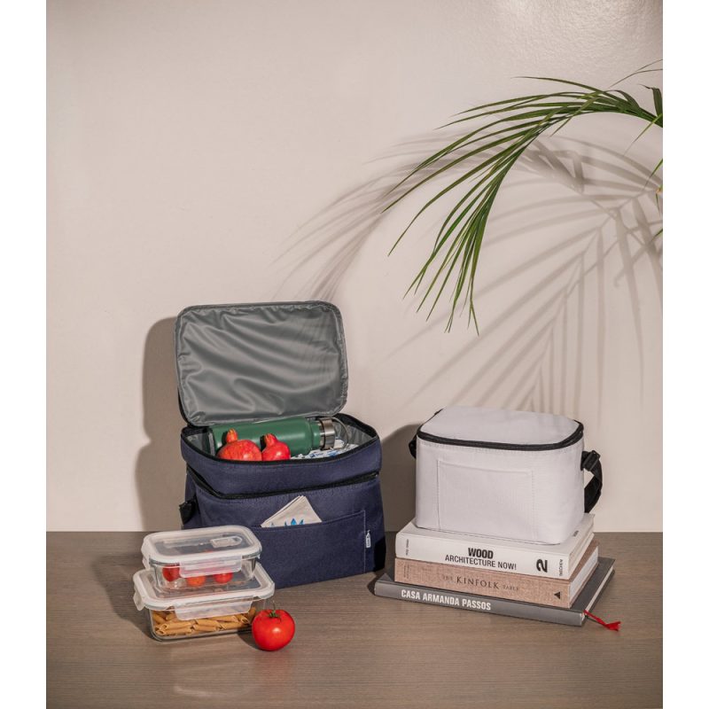 Lunch boxes and fruit on a table.