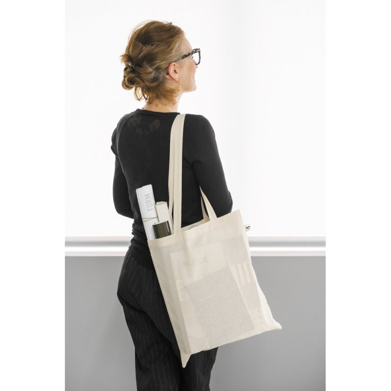 Woman with tote bag featuring magazines