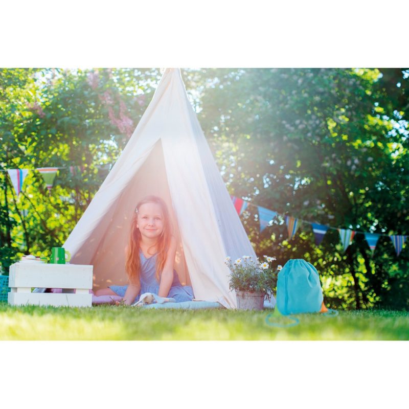 Smiling girl in garden tent with bunting.