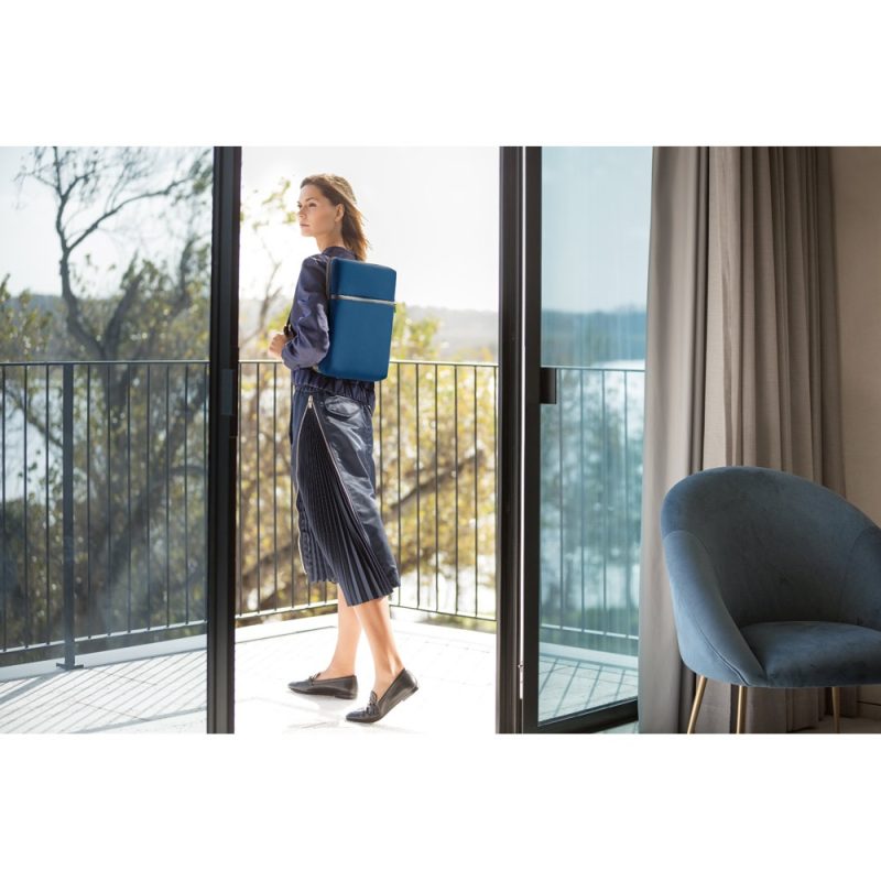 Woman with blue backpack on balcony.