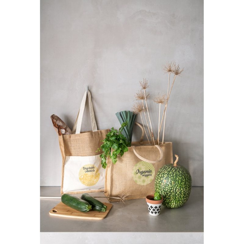 Eco bags with organic vegetables on table.