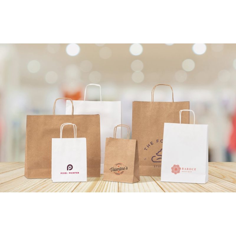 Assorted branded paper bags on wooden surface.