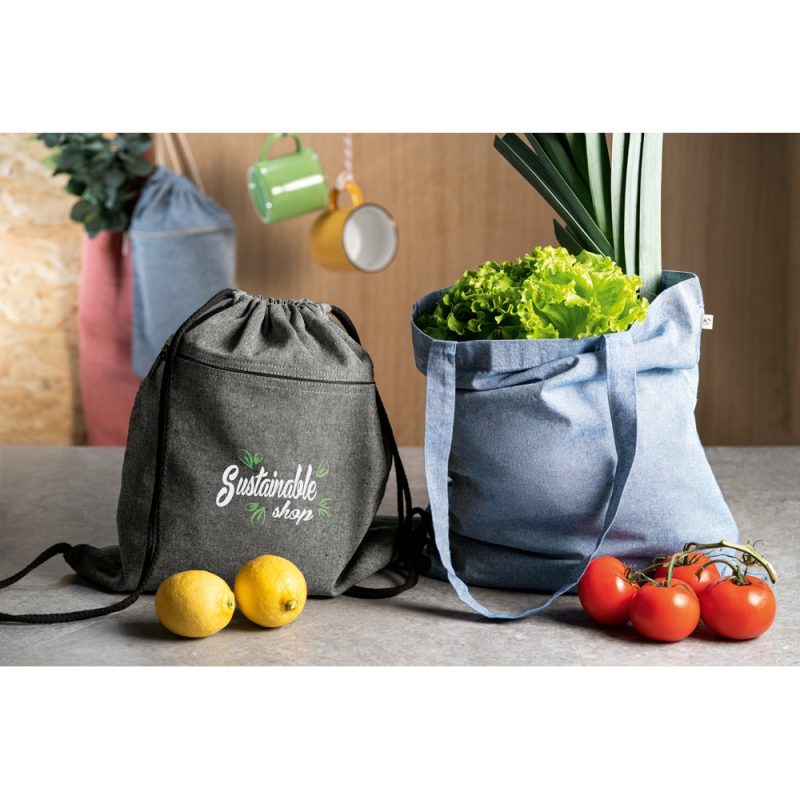 Reusable bags with produce and lemons on table.