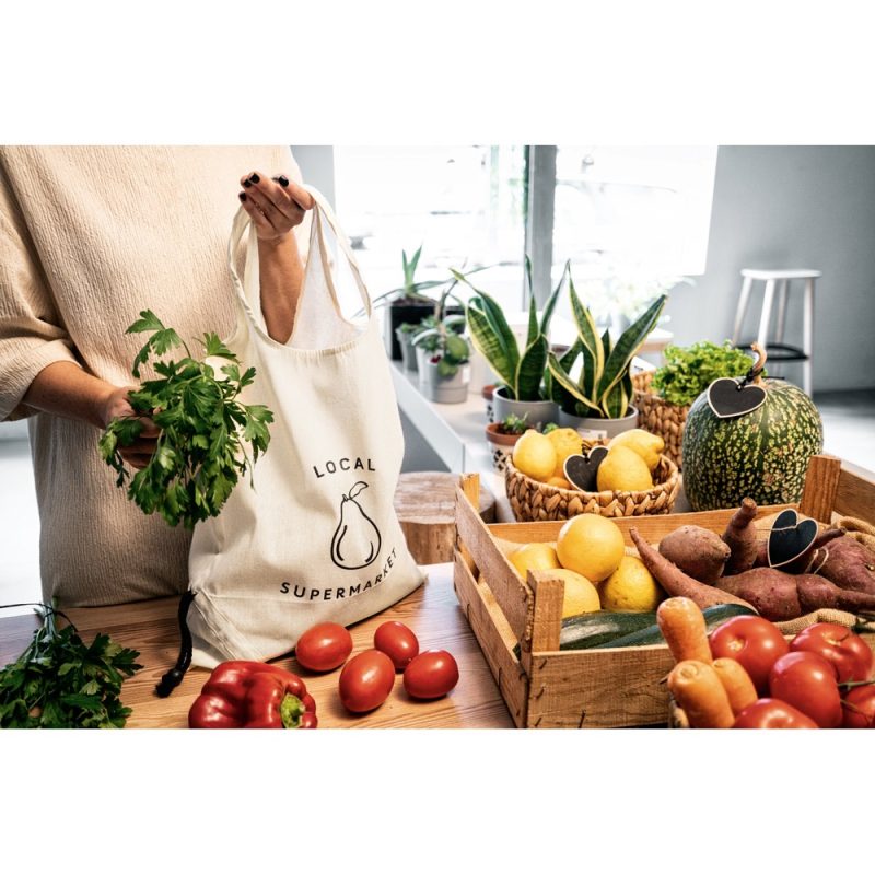 Person buying fresh vegetables at local supermarket.