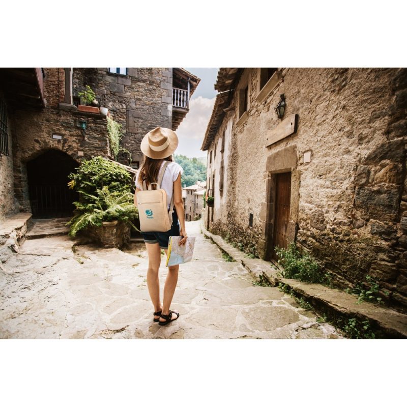 Traveller exploring charming cobblestone village street.