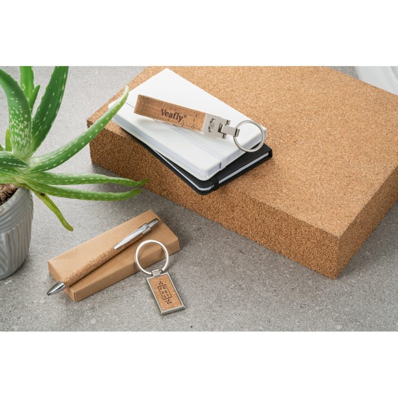 Eco-friendly stationery items on a cork board.