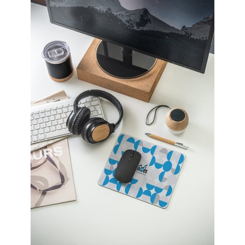 Office desk with keyboard, mouse, headphones, and computer screen.