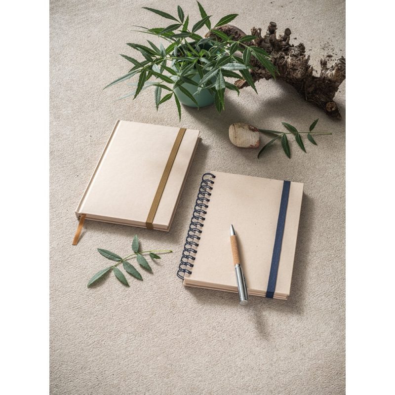Notebooks with a pen and plant arrangement