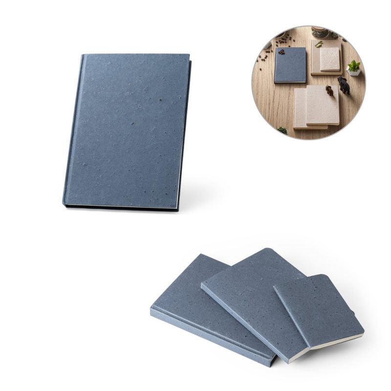 Blue notebooks in various sizes on wooden table.