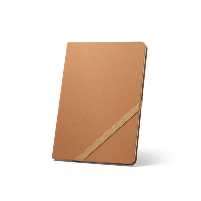 Brown notebook with elastic strap standing upright.