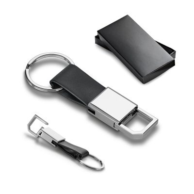 Metal keychain with black strap and box.