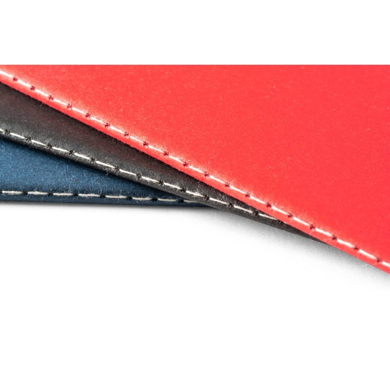 Close-up of red and blue leather stitching.