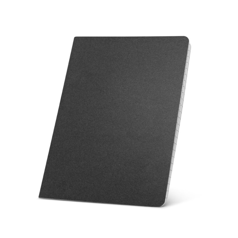Black notebook with graph paper pages, tilted angle.