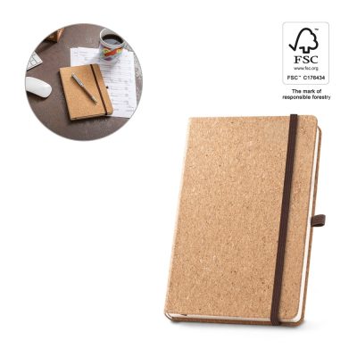 Cork notebook with pen and coffee on desk.