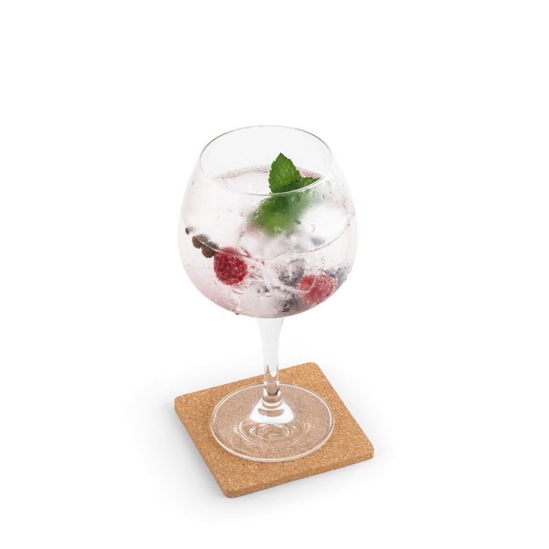 Glass with berries and mint cocktail on coaster