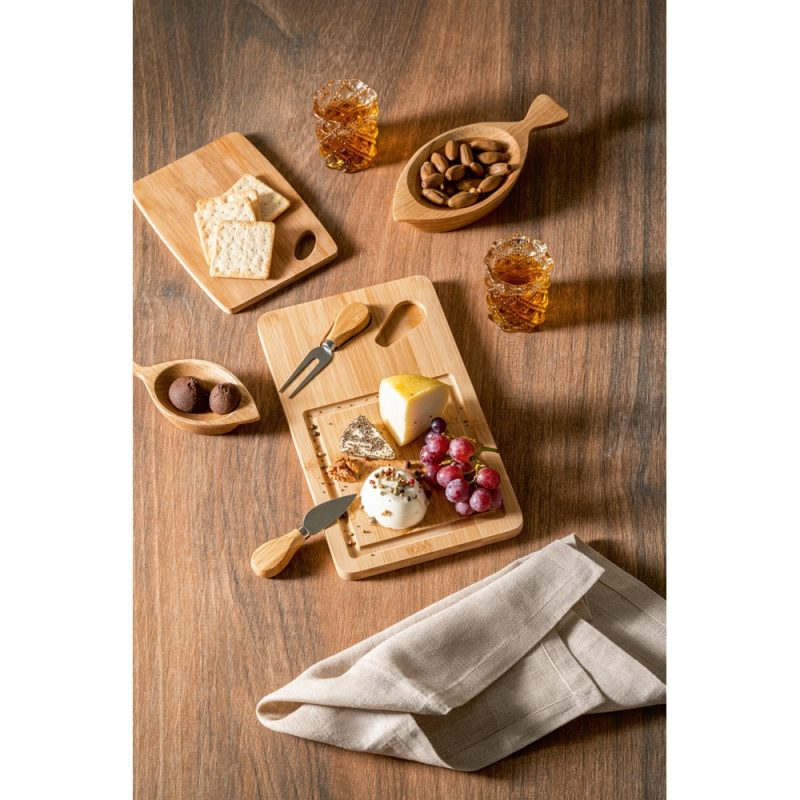 Cheese board with crackers and nuts on a table.