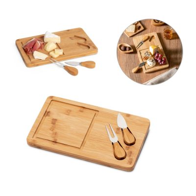 Bamboo cheese board with knives and cheese selection.