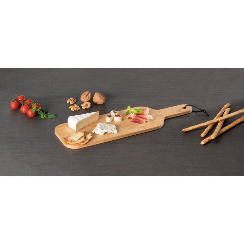 Cheese and charcuterie board with nuts and breadsticks.